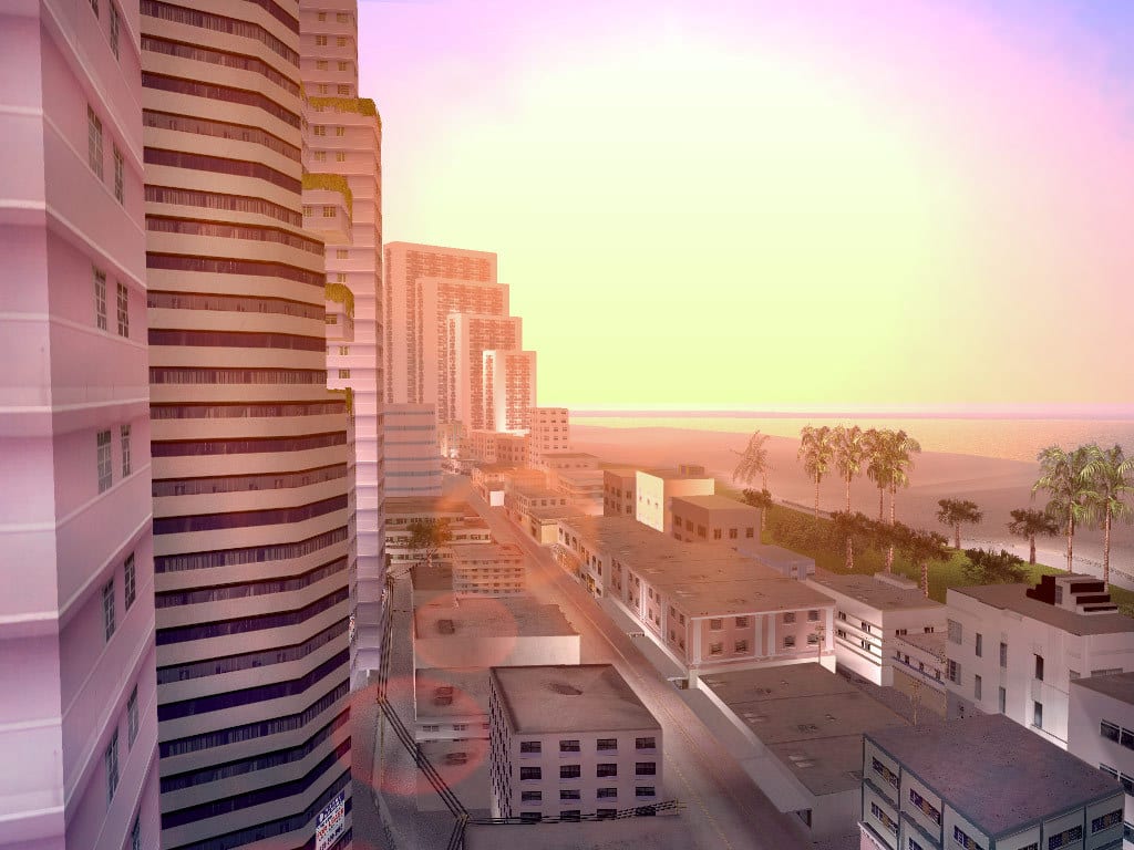 Grand Theft Auto Vice City oceanfront skyline with pastel towers, palm trees, and a sunset beach